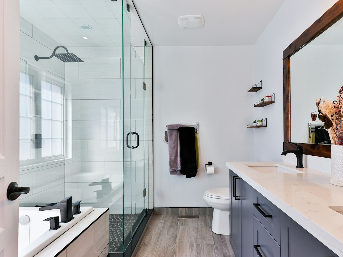After: glass shower enclosure with a soaking tub and vanity
