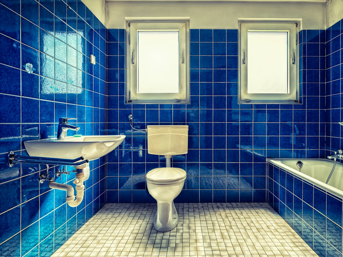 Before: dated blue-tiled bathroom